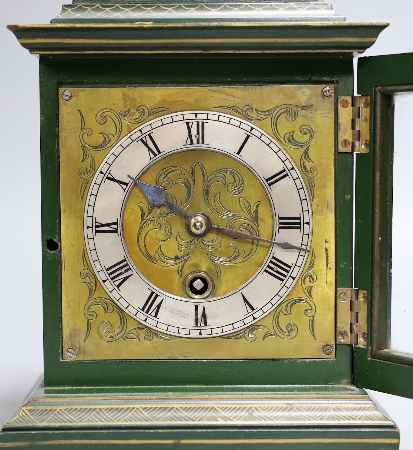 A 1920's green japanned mantel timepiece, 26 cms high